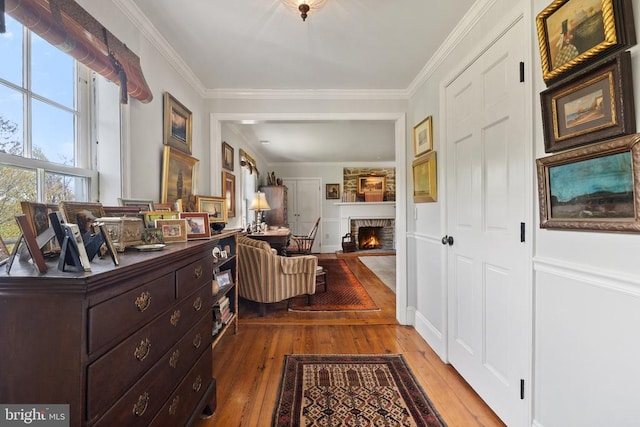 hall featuring wood-type flooring and crown molding