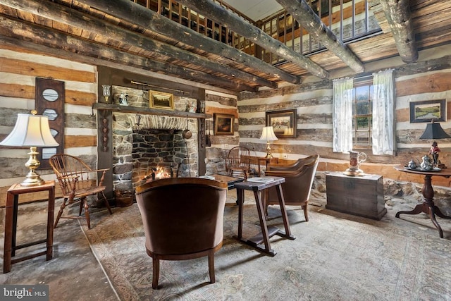 sitting room featuring concrete flooring and wooden walls
