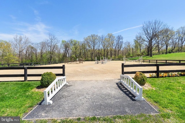 view of property's community with fence, an enclosed area, and a yard