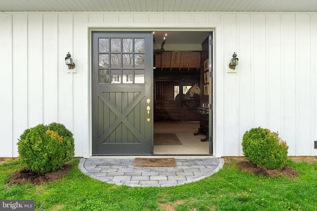view of exterior entry with board and batten siding