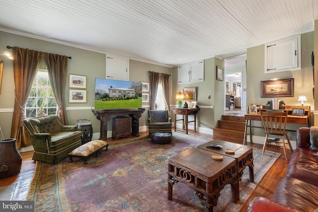 living area with wood finished floors and crown molding