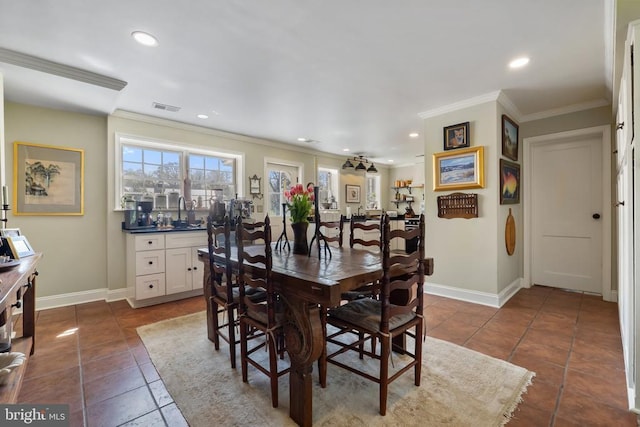 dining room featuring visible vents, dark tile patterned flooring, ornamental molding, and baseboards