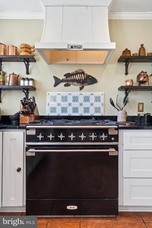 room details with custom exhaust hood, white cabinetry, open shelves, black range with gas stovetop, and crown molding