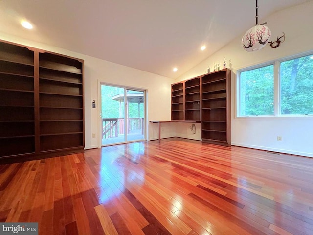 unfurnished living room with hardwood / wood-style floors, lofted ceiling, recessed lighting, and baseboards