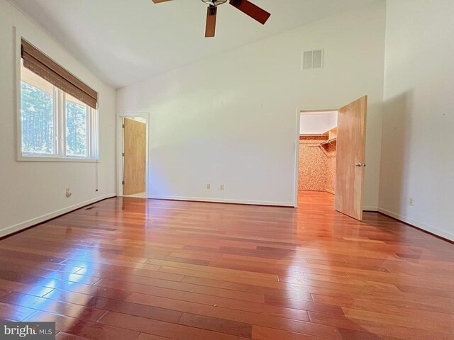 spare room featuring ceiling fan, high vaulted ceiling, and light hardwood / wood-style flooring