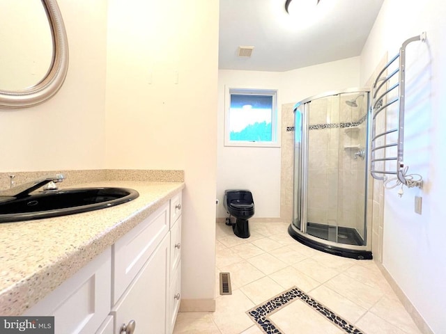 bathroom with tile patterned floors, visible vents, a stall shower, baseboards, and vanity