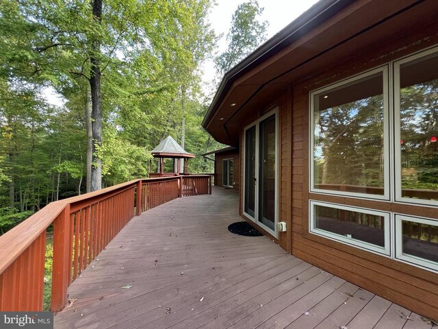 wooden terrace featuring a gazebo