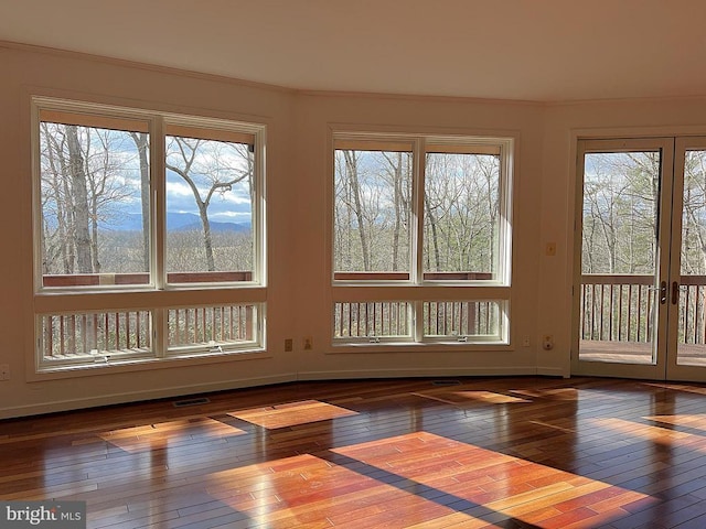 unfurnished sunroom featuring visible vents and french doors