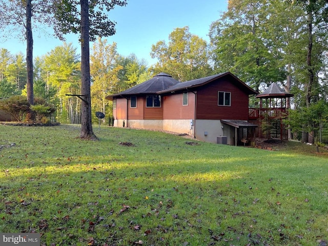 view of home's exterior featuring a yard and central AC