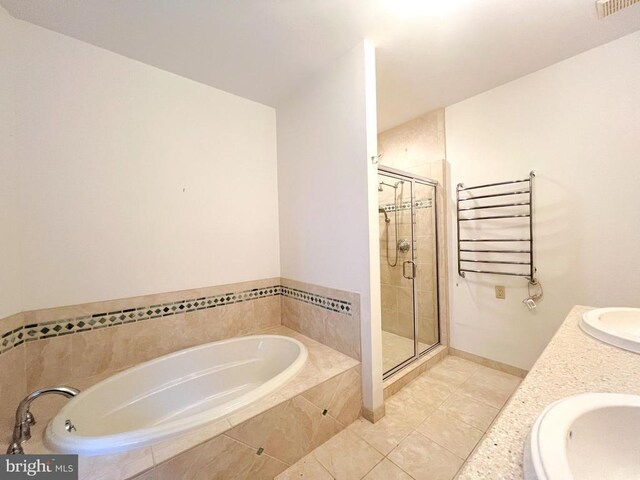 bathroom with tile patterned flooring, vanity, radiator heating unit, and shower with separate bathtub