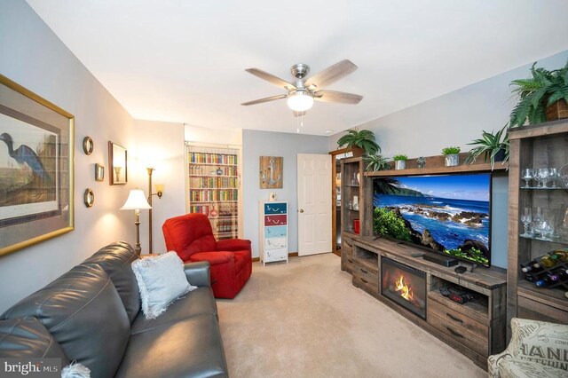 living room featuring light carpet and ceiling fan