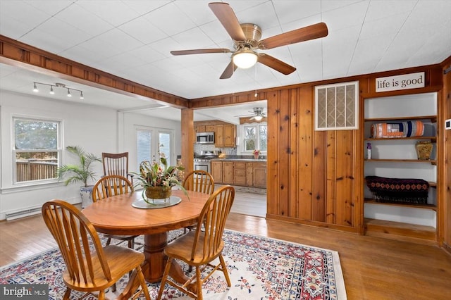 dining space with plenty of natural light, light wood-style floors, and a ceiling fan