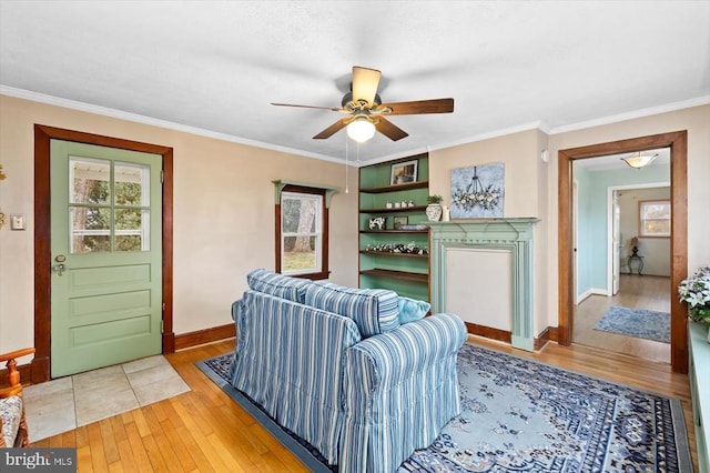 living room featuring light wood-style flooring, ceiling fan, and ornamental molding