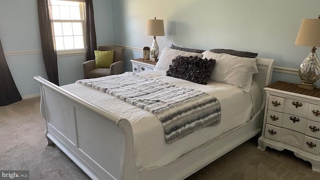 carpeted bedroom featuring baseboards
