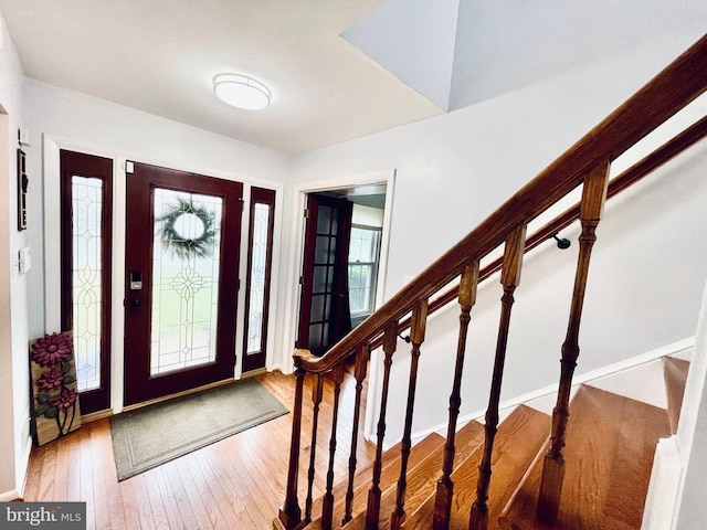 entrance foyer featuring stairs and hardwood / wood-style flooring