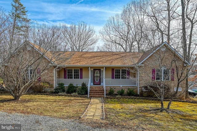 single story home featuring a front yard and covered porch