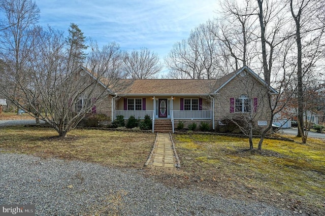 ranch-style home with a porch, a front lawn, and a shingled roof