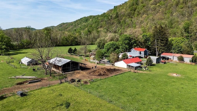 birds eye view of property with a forest view and a rural view