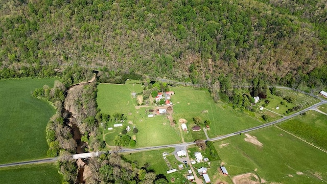 bird's eye view with a wooded view