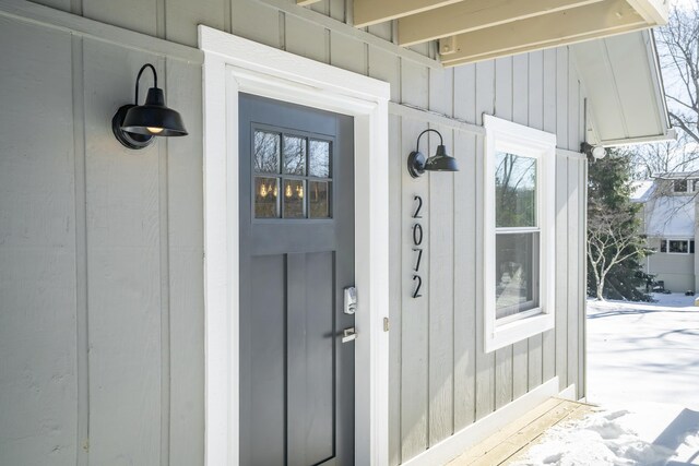 view of snow covered property entrance