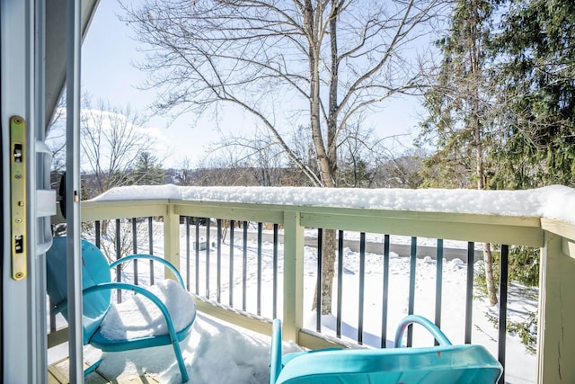 view of snow covered back of property