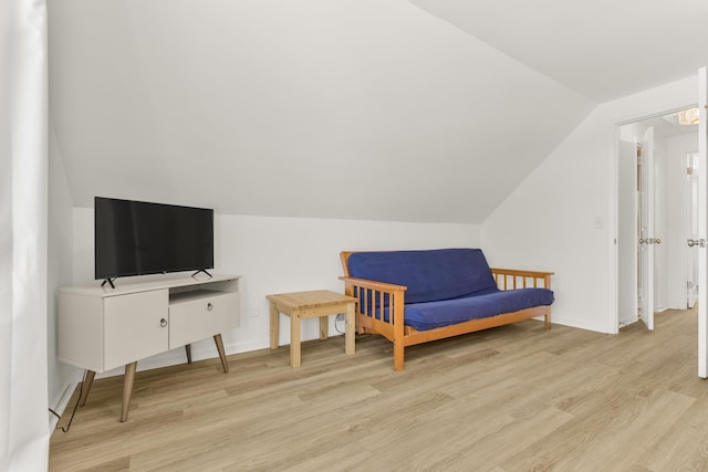 sitting room with lofted ceiling and light wood-type flooring