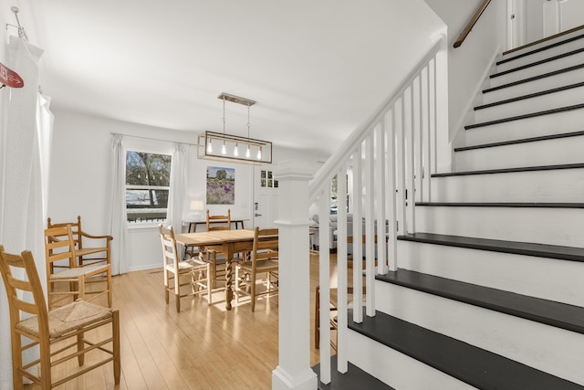 staircase with hardwood / wood-style floors