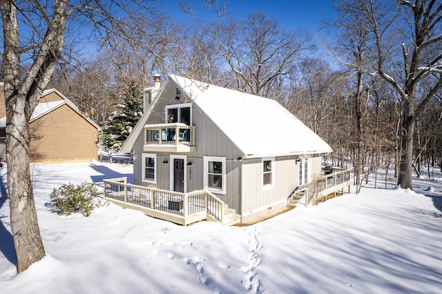 snow covered property featuring a balcony