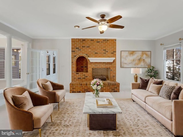 carpeted living room with crown molding, ceiling fan, and a fireplace