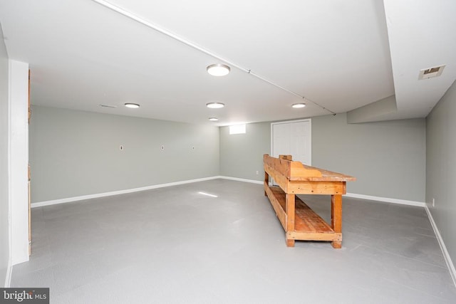 interior space with finished concrete flooring and baseboards