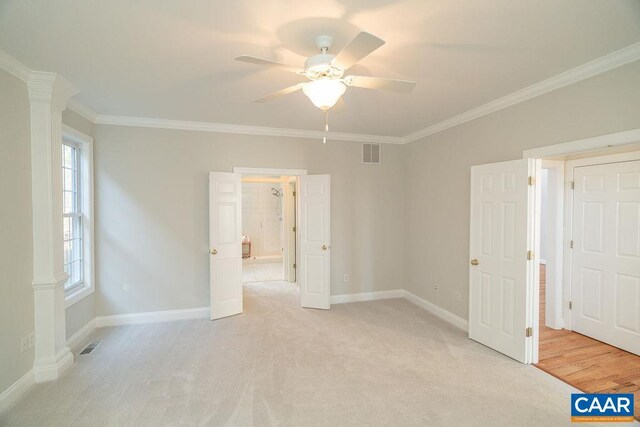 unfurnished bedroom with ornamental molding, light colored carpet, visible vents, and baseboards