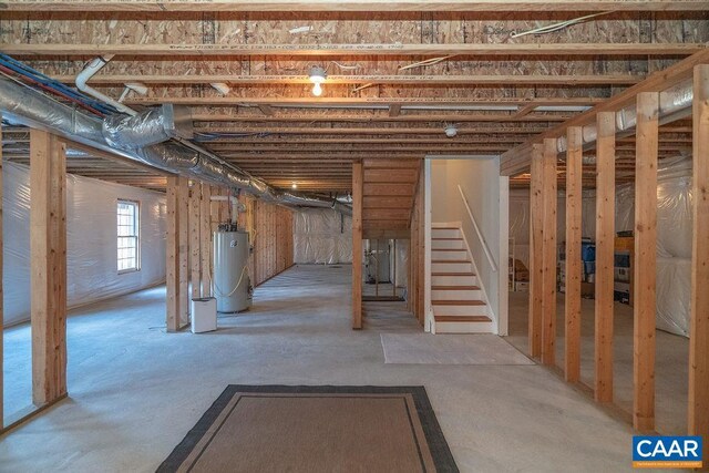 below grade area featuring stairway and gas water heater