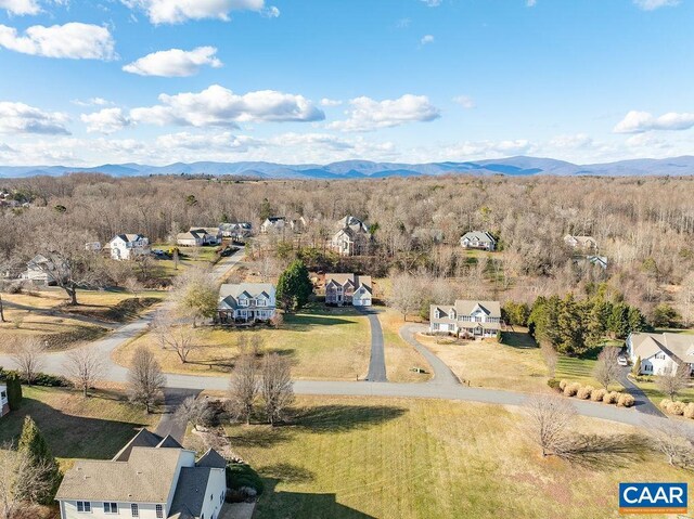 aerial view featuring a mountain view and a view of trees