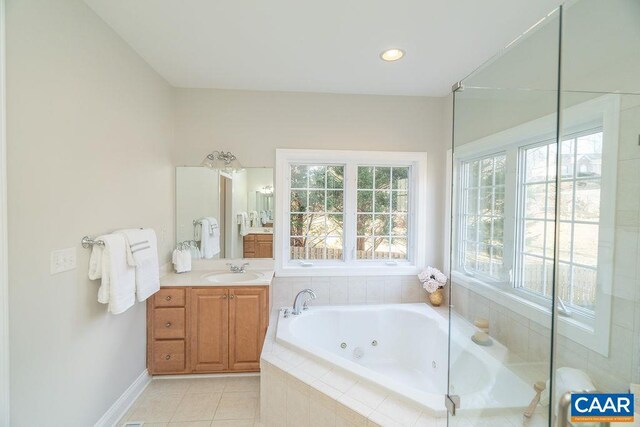 full bath with recessed lighting, vanity, a whirlpool tub, baseboards, and tile patterned floors