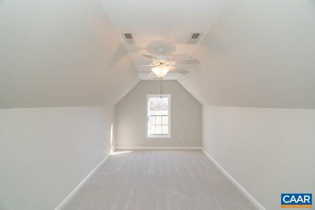 additional living space with visible vents, light carpet, and baseboards