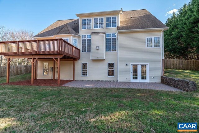 back of house with a patio, roof with shingles, fence, a deck, and a yard