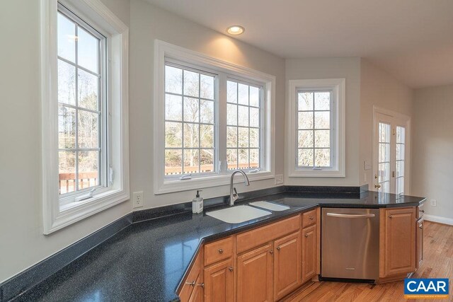 kitchen with brown cabinets, light wood finished floors, recessed lighting, a sink, and dishwasher