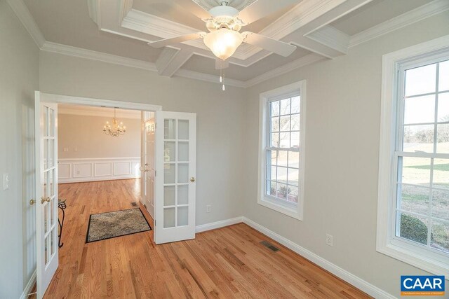 spare room featuring french doors, visible vents, crown molding, and light wood-style flooring