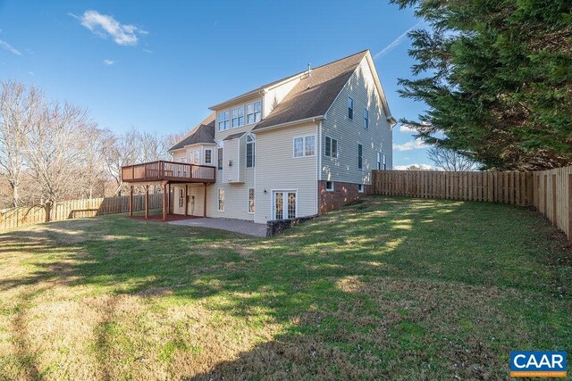 rear view of house with a yard, a patio area, a fenced backyard, and a wooden deck