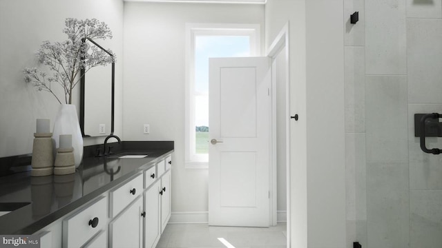 bathroom with tiled shower and vanity