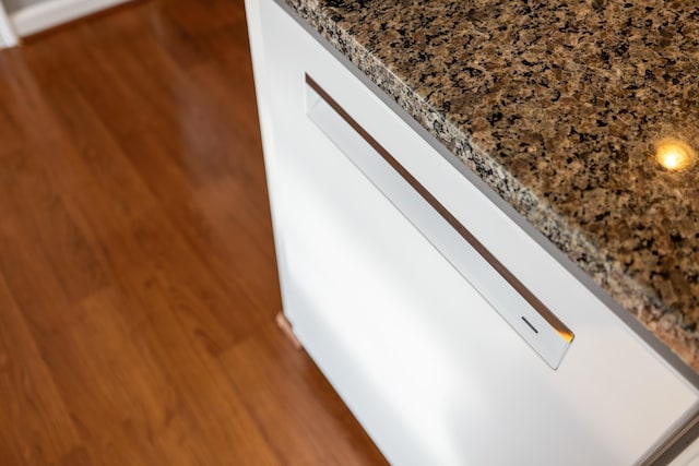 interior details with stone countertops and wood finished floors