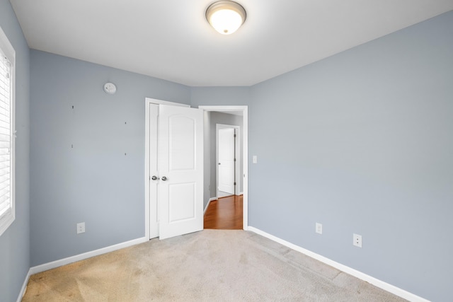carpeted spare room with baseboards