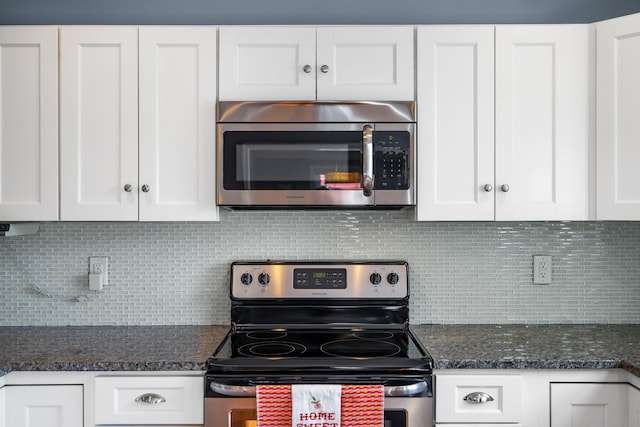 kitchen with appliances with stainless steel finishes, backsplash, and white cabinetry