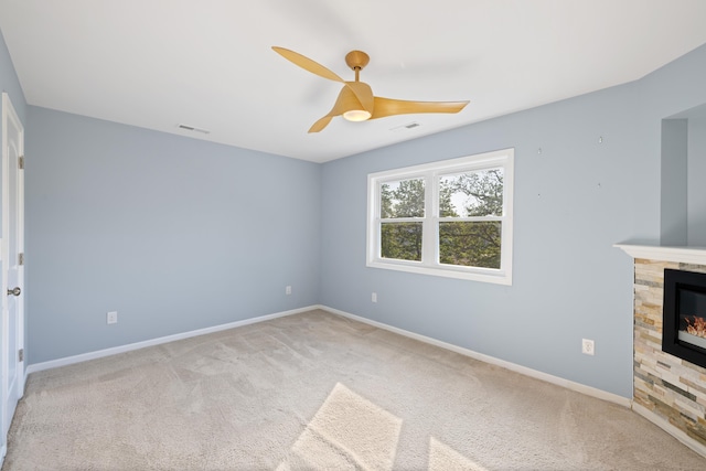 unfurnished living room featuring visible vents, baseboards, ceiling fan, and carpet floors
