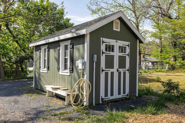 view of shed featuring fence