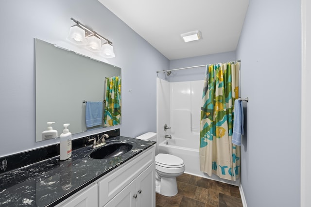 bathroom with vanity, shower / bath combination with curtain, toilet, and stone finish flooring
