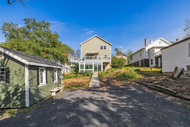 rear view of property featuring a balcony