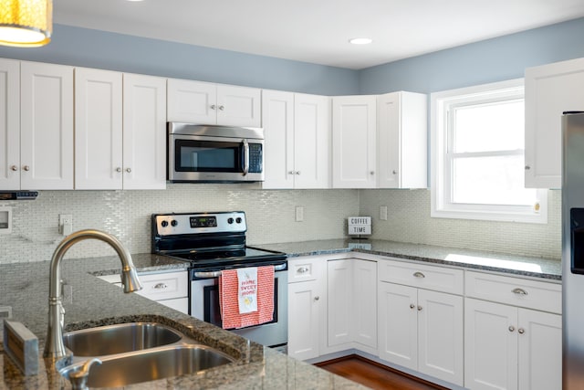 kitchen featuring a sink, white cabinets, backsplash, and stainless steel appliances