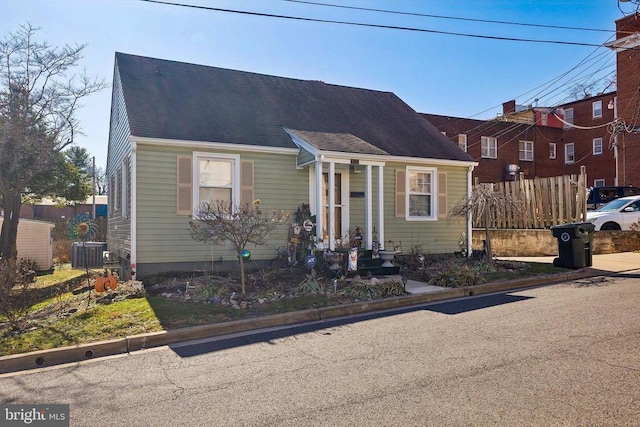 bungalow-style house with central air condition unit