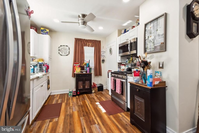 kitchen with white cabinetry, dark hardwood / wood-style flooring, ceiling fan, and appliances with stainless steel finishes